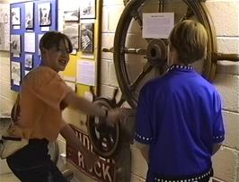 Nick and Matthew steer the ship at the Heritage and Shipwreck Museum, Charlestown